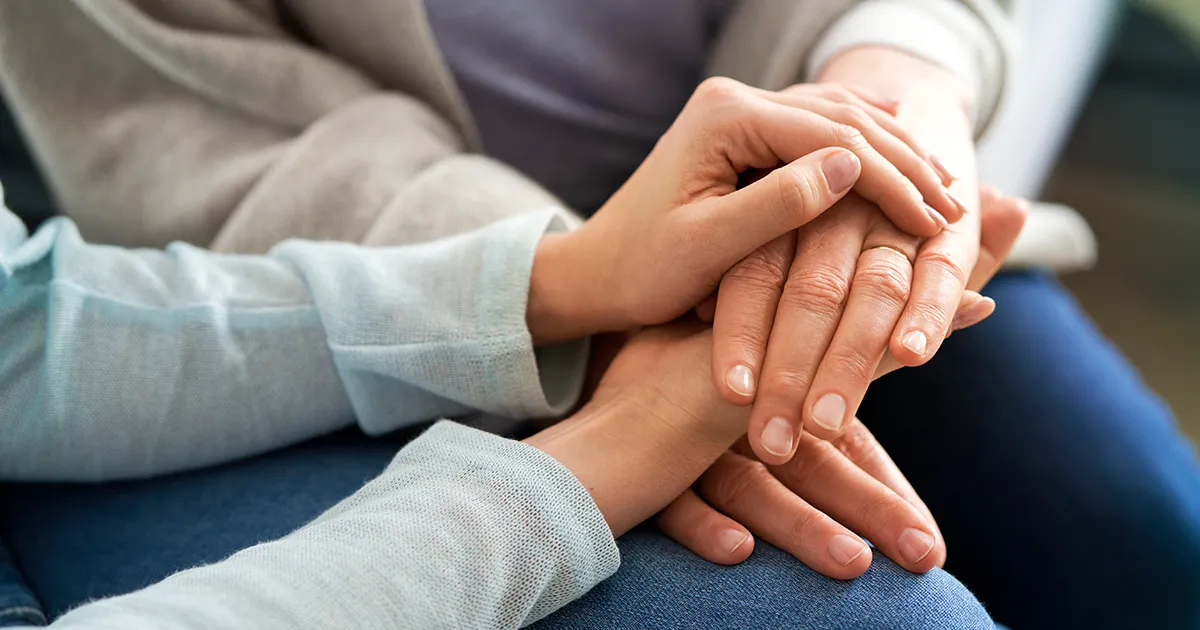 Hands reaching toward each other symbolizing hope and connection during National Suicide Prevention Week