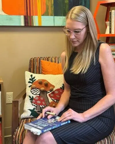 Dr. Erin Amato holding Think Outside the Bottle